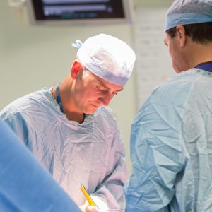 Surgeon operating on patient in operating theatre