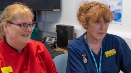 Two female staff members working together at a computer