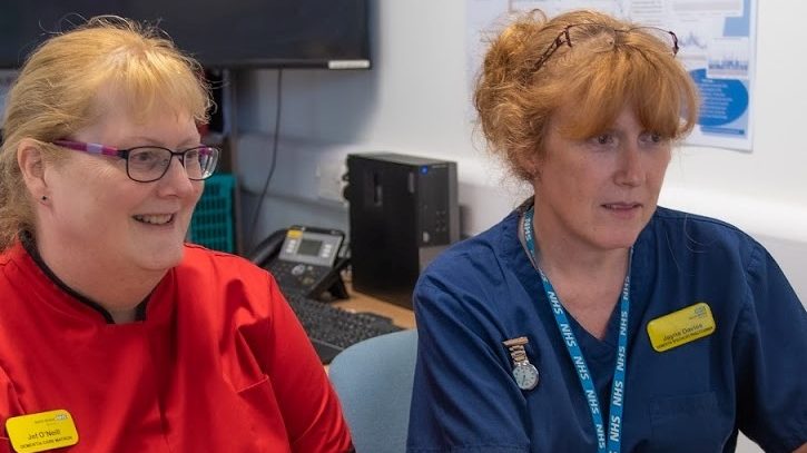 Two female staff members working together at a computer